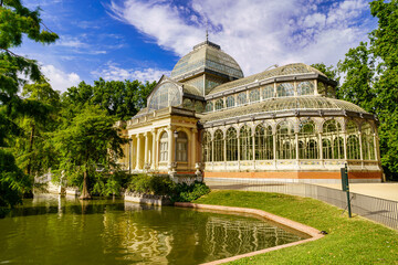 Fototapeta na wymiar Palacio de Cristal in Madrid's Retiro public park with its lake on the main façade.