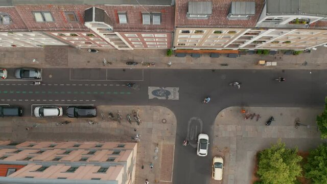 Aerial birds eye overhead top down tracking view of bikers in Linienstrasse. Street adapted for cycle route where cyclists have priority. Promoting green transport in city. Berlin, Germany.