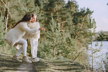 Elegant mother with daughter in a summer forest
