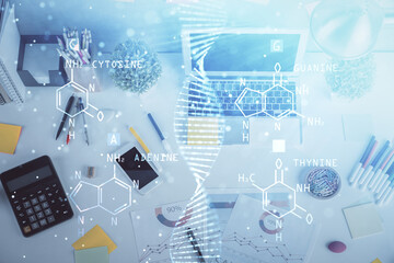 DNA hologram drawings over computer on the desktop background. Top view. Multi exposure. Concept medical education.