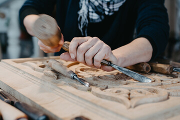 photographs of a woman engaged in hand-carving