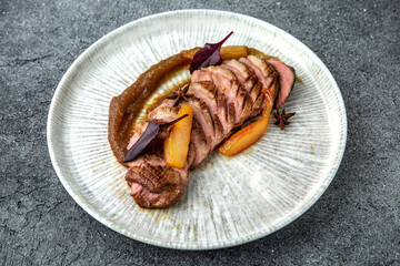 Duck fillet with apple or peach jam. Ready menu for the restaurant. Neutral gray blue textured background