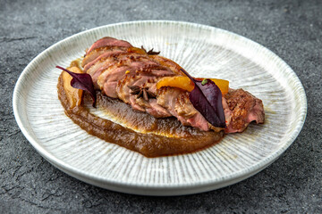 Duck fillet with apple or peach jam. Ready menu for the restaurant. Neutral gray blue textured background