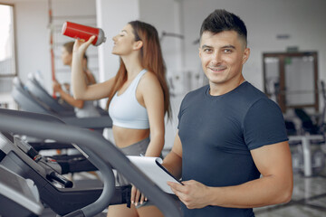 Fototapeta premium Young sports people training in a morning gym