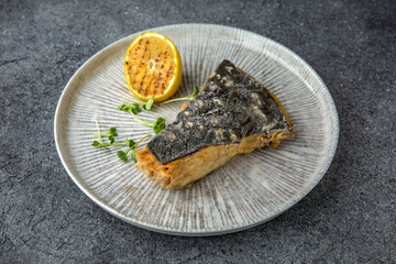 Fillet of white fish grilled or steamed. Diet nutritious meal. Ready menu for the restaurant. Neutral gray blue textured background