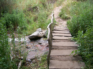 Wooden bridge over the river for the passage in the mountains 
