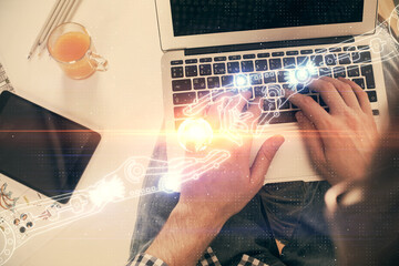Multi exposure of man's hands typing over computer keyboard and data theme hologram drawing. Top view. Technology concept.