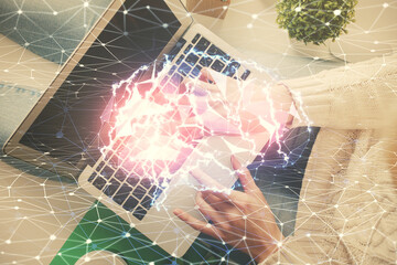 Double exposure of woman working on computer andhuman brain hologram drawing. Top View. Ai concept.