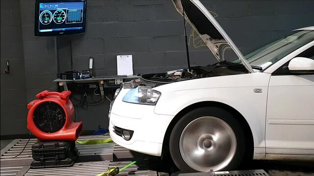 Car performing a power run on a rolling road (chassis dynamometer)