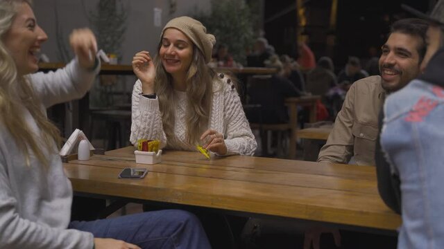 Rumor gossip with mixed friends over drinks at a pub