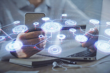 Double exposure of man hands holding a credit card and social network theme drawing. Digital finance and E-commerce concept.