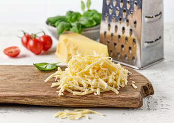 grated cheese on wooden cutting board