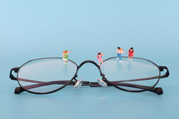 Miniature dolls elementary school students on glasses