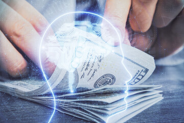 Multi exposure of brain drawing hologram and us dollars bills and man hands. Ai invest concept