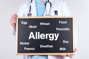 Doctor with a board with the word allergy and some foods that cause allergies
