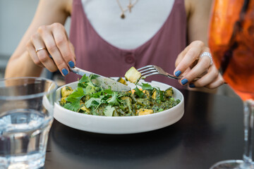 Person eating salad close up