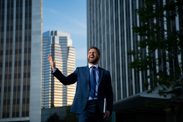 Businessman with success business. Outdoors portrait male model in suit.