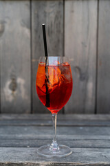 Glass of Aperol Spritz cocktail on the rustic background