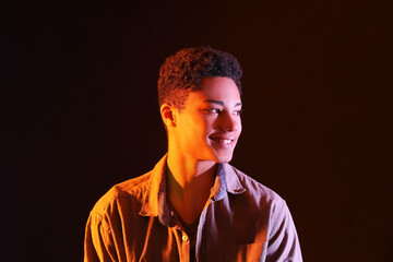 Portrait of African-American teenage boy on dark background