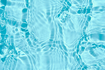 Blue water surface background. Water texture with splashes and bubbles. Summer nature background