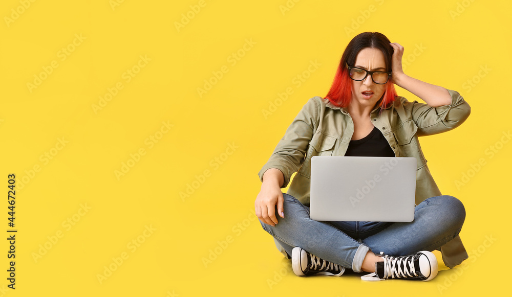 Poster upset female programmer using laptop on color background