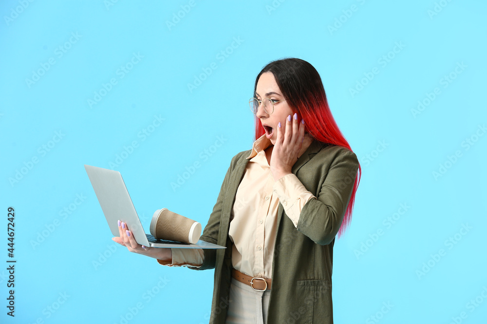 Poster shocked female programmer using laptop on color background