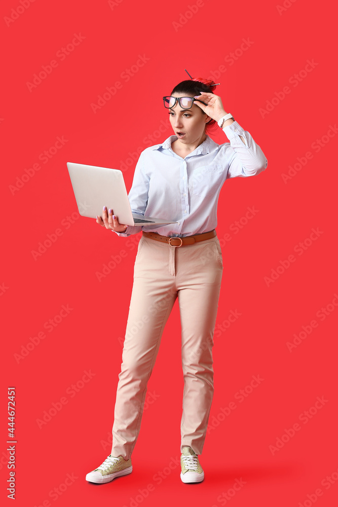Poster shocked female programmer using laptop on color background