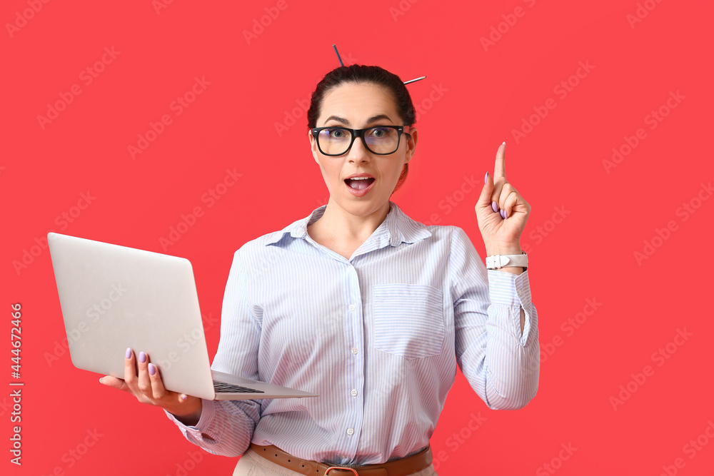 Poster female programmer with raised index finger and laptop on color background