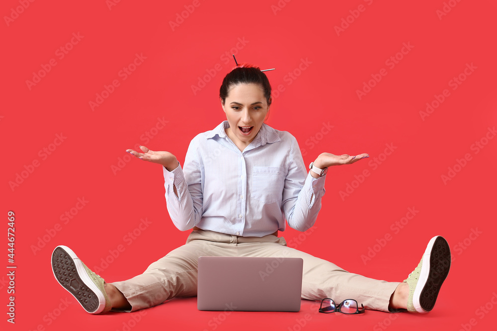 Poster surprised female programmer using laptop on color background