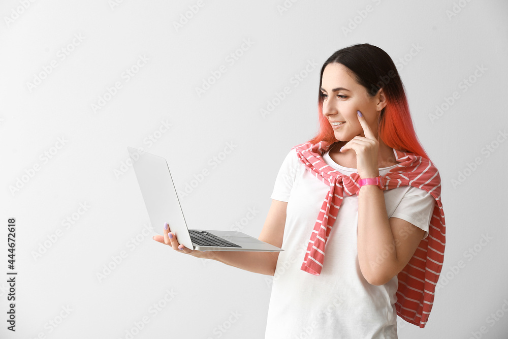 Poster female programmer using laptop on light background
