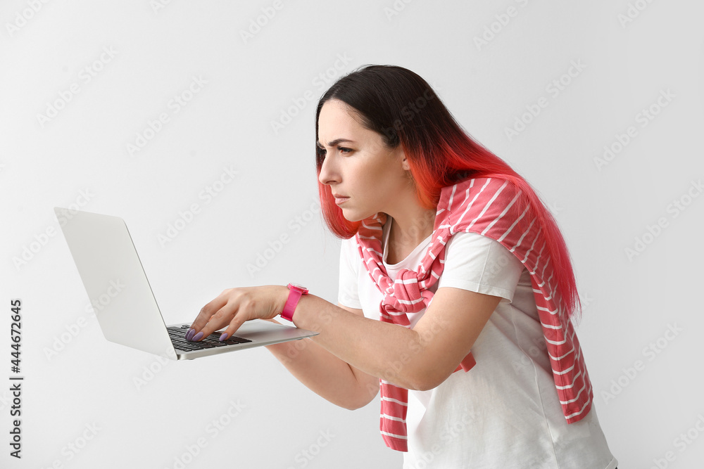 Poster female programmer using laptop on light background