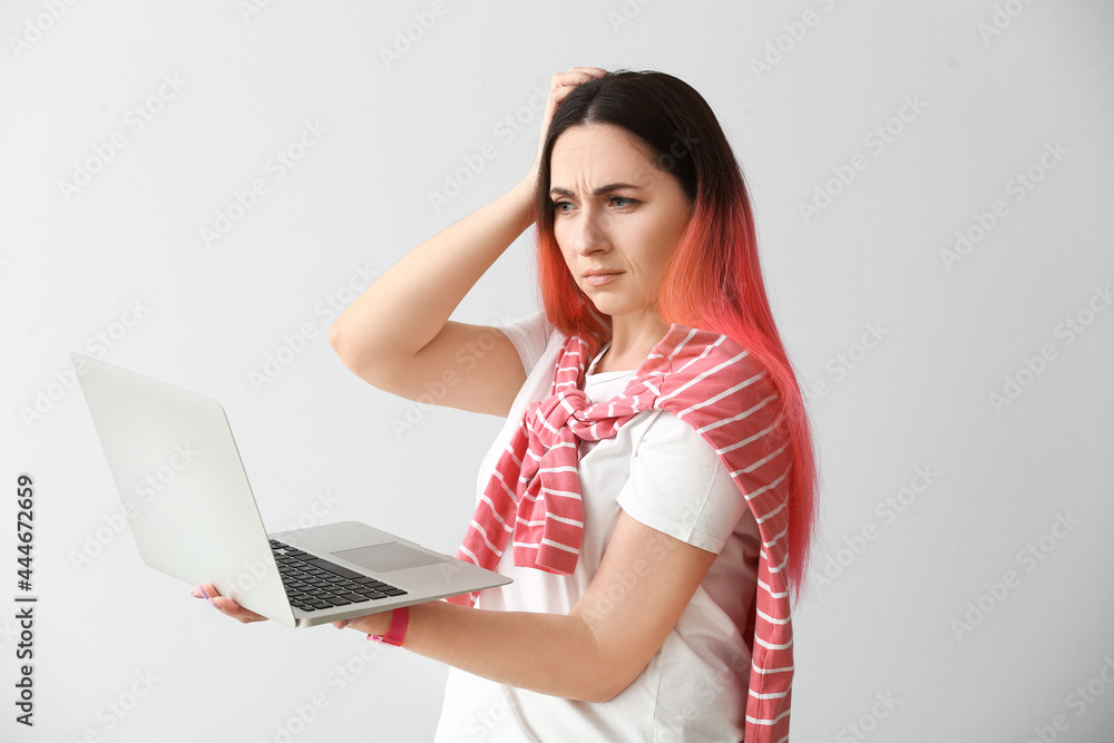 Poster female programmer using laptop on light background