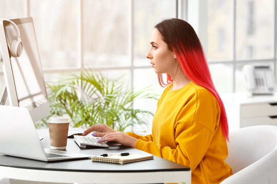 Female programmer working with computer in office