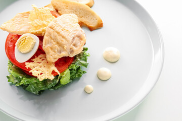 Plate with Caesar salad on white background, closeup