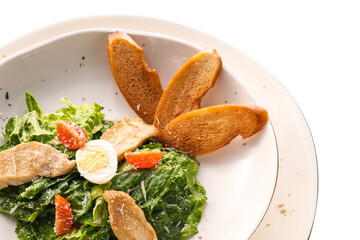 Plate with Caesar salad on white background, closeup