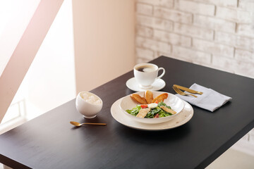 Plate with Caesar salad on table in restaurant