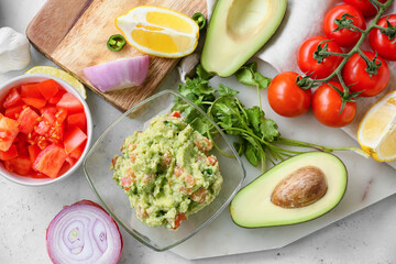Composition with tasty guacamole and vegetables on light background