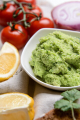 Bowl with tasty guacamole on table, closeup