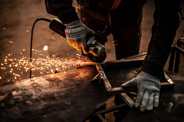 Metal processing in the workshop. Grinding metal.