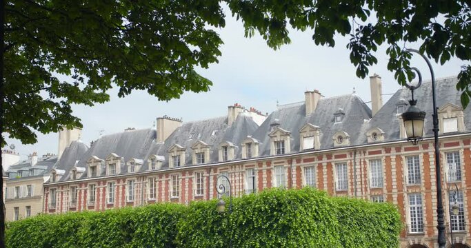 Place des Vosges in Paris. France. Shot in 4K (ultra-high definition (UHD)). Historical Square at autumn. Arcade on the Place des Vosges in Paris. Sliding shot in 4k.