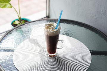 Viennese coffee with whipped cream on the coffee table in the cafeteria
