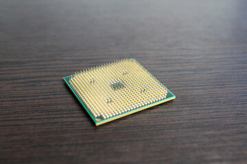 Processor contacts up against a dark wood background