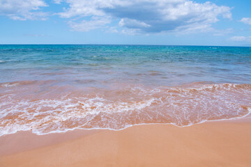 Calm sea beach background. Summer tropical beach with sand. Ocean water. Natural seascape.