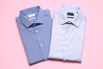 Stylish male shirts on color background