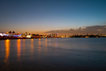 Fototapeta premium Miami city. Miami skyline panorama at dusk with skyscrapers over sea. Night downtown sanset.