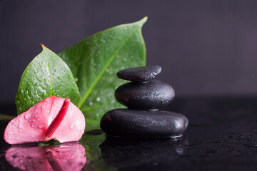 Zen concept balancing dark stones on mirrored background