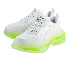 Pair of new fashionable white leather sneakers, on a neon green polyurethane sole, isolated on a...