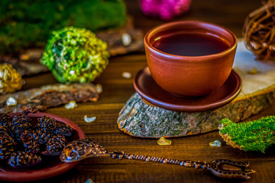 tea in a clay cup a beautiful spoon in oriental style on a wooden background