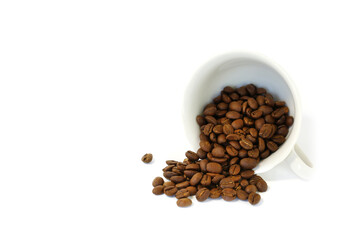 Coffee beans are pouring out of the coffee cup.