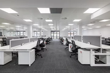 Foto op Plexiglas Modern corporate open office in minimalist modern design in whites and greys, empty office workstations. © Pavel